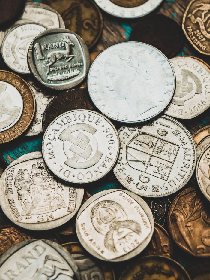 Crafting Captivating Headlines: Your awesome post title goes here Close-up shot of various international coins showcasing currency diversity.