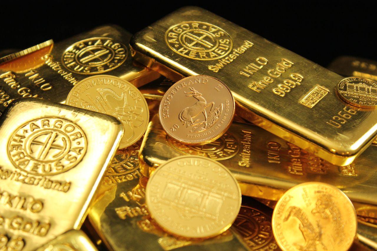 our-story A detailed image of gold bars and coins symbolizing wealth and financial investment.